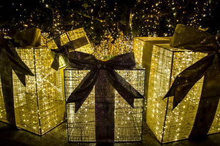 LVIV, UKRAINE - DECEMBER 18: Golden Christmas and New Year gifts under the Christmas tree in the center of Lviv on December 18, 2017 in Lvov, Ukraineのeditorial素材