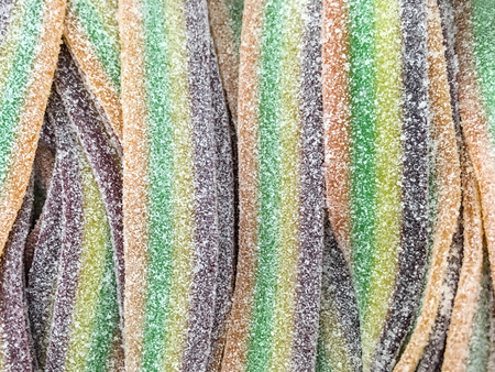 Food background - Appetizing jelly candies in the form of strips close-up