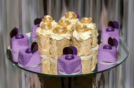 Appetizing cakes on a glass table on an abstract background close-upの写真素材