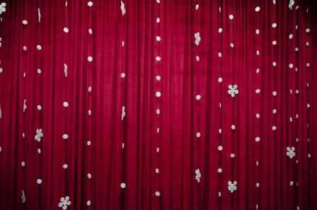 New Year background - White snowflakes on a red velvet curtainの写真素材