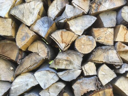 Stacked firewood (woodpile) for the stove in the open air close-upの写真素材