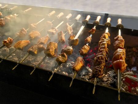 Food background - Kebab (barbecue, shashlik) meat is grilled on the grillの写真素材