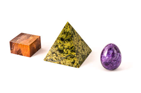 Three marble primitives standing in row on white backgroundの写真素材