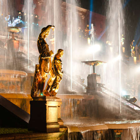 Sculptures with fountain on background at night at Petergof, Russiaの写真素材