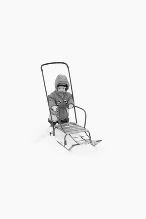 The child moves the sled in winter.