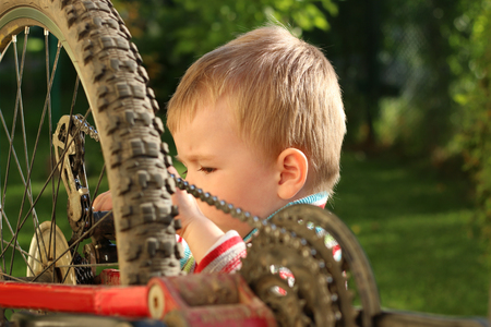 Little boy repairing bike adultの写真素材