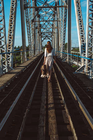 girl goes on railway bridgeの写真素材