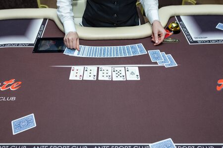 A tailor hands out cards at a casino