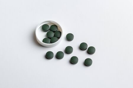 green pills isolated on a white backgroundの写真素材