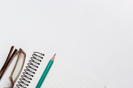 notebook, pen and glasses on white background isolatedの写真素材