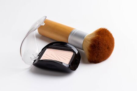 makeup powder and brush isolated on white backgroundの写真素材