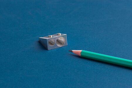 isolated pencils with sharpener on blue backgroundの写真素材
