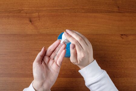 Woman spraying alcohol gel or antibacterial soap sanitizer.sanitizer in pump bottle, for killing germs, bacteria and virus.の写真素材