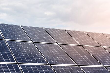 Close-up view of solar panels on a background of sunny blue skyの写真素材