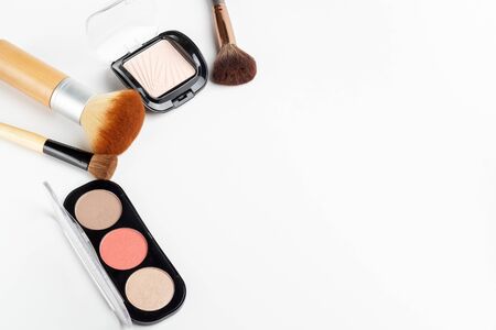 Makeup brushes of different sizes and makeup powder on a white background. Top view.の写真素材