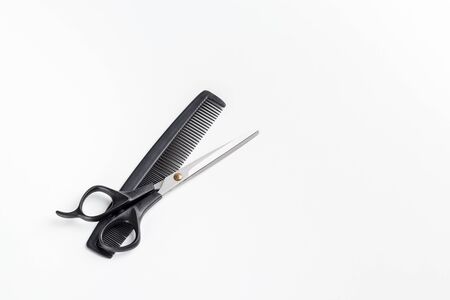 scissors and comb on a white background. Place for textの写真素材