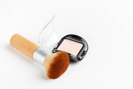 makeup powder and brush isolated on white backgroundの写真素材