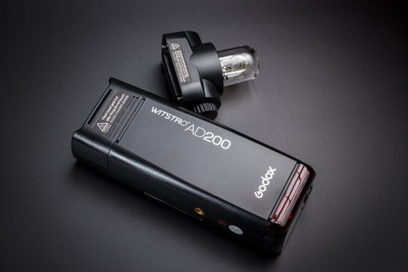 Kamyanets-Podilskyi, Ukraine - May 22, 2020: Studio flash Godox AD200 and removable head for scattered light on a black backgroundのeditorial素材