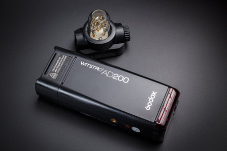 Kamyanets-Podilskyi, Ukraine - May 22, 2020: Studio flash Godox AD200 and removable head for scattered light on a black backgroundのeditorial素材