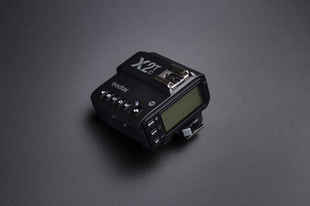 Kamyanets-Podilskyi, Ukraine - May 22, 2020: Radio synchronizer transmitter Godox X2T-C on black background.のeditorial素材