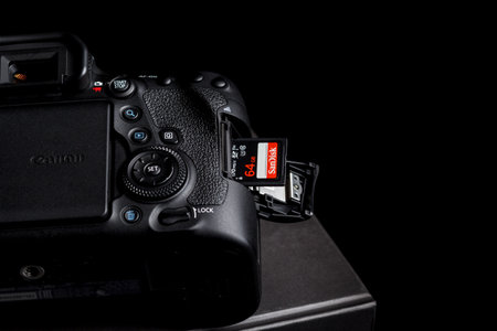 Kamyanets-Podilskyi, Ukraine - May 22, 2020: Canon EOS 6D Mark II Body and Sandisk memory card in slot on black backgroundのeditorial素材