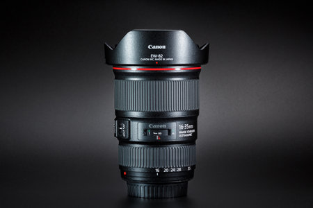 Kamyanets-Podilskyi, Ukraine - May 22, 2020: Canon EF 16-35mm f / 4L IS USM Lens on black background.のeditorial素材