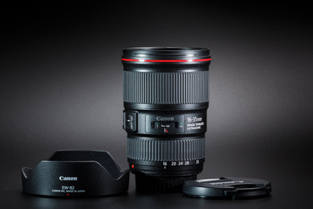 Kamyanets-Podilskyi, Ukraine - May 22, 2020: Canon EF 16-35mm f / 4L IS USM Lens on black background.のeditorial素材