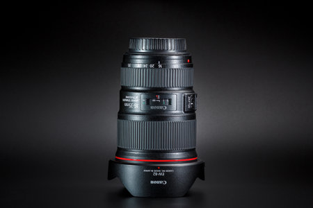 Kamyanets-Podilskyi, Ukraine - May 22, 2020: Canon EF 16-35mm f / 4L IS USM Lens on black background.のeditorial素材