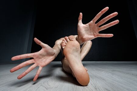 Contemporary dance positions. Absraction "Moose". Foot between hands.の写真素材
