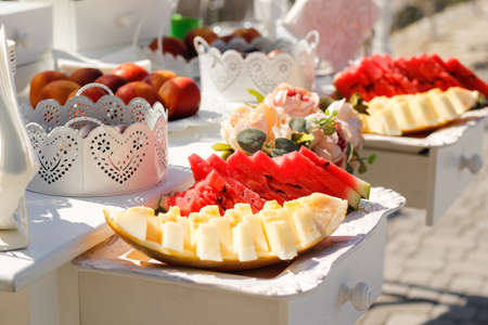 Slices of watermelon and melon on a buffet table selective focusの写真素材