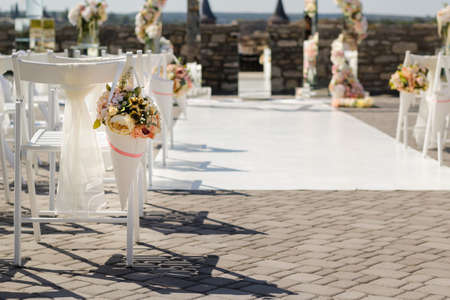 Basket with flowers on the back of a chair at a wedding ceremony, selective focusの写真素材
