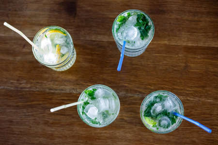 Lemonade and fresh mojito cocktails on the table in a cafeの写真素材