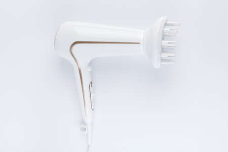 Hairdryer with a diffuse styling attachment on a white backgroundの写真素材