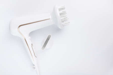 Hairdryer for drying hair with a diffuse and flat nozzle for styling on a white background. Top...