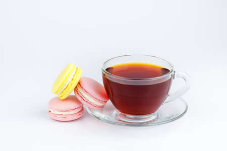 Cup of tea and colorful macaroons on a white background.の写真素材