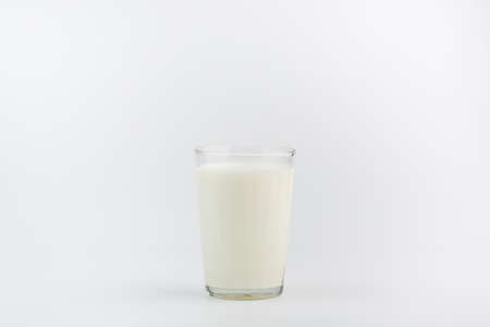A glass of milk on a white backgroundの写真素材
