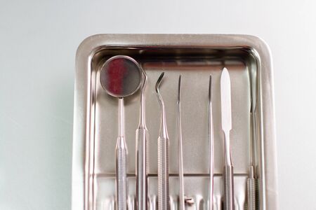 Set of professional dentist tools. Doctors tools in a metal trayの写真素材