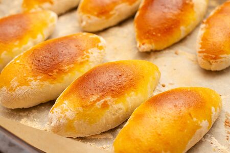 oven-baked pastry pies on a baking sheet