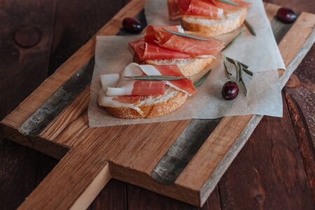 Cured meat served on wooden board. Top viewの写真素材