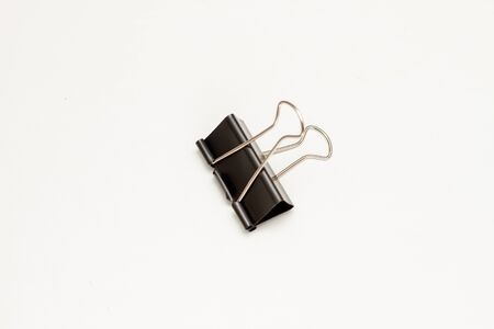 One black binder clip for papers isolatedの写真素材