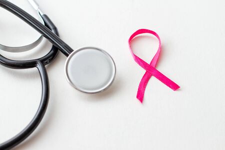 Breast cancer awareness, with stethoscope on white background. Health care concept