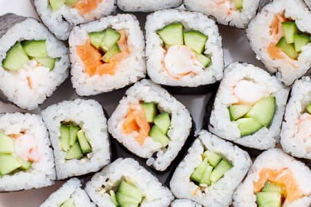 Japanese set of sushi rolls, close up on white background.