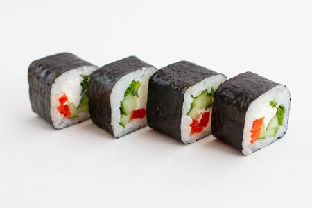 Sushi rolls with vegetables on a white backgroundの写真素材