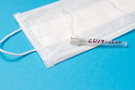 respiratory mask and needle test tube with coronavirus 2019-nCoV inscription, CHINA