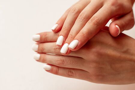 gentle women hands with manicure on a white backgroundの写真素材