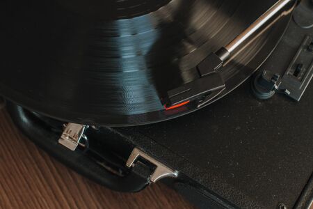 vinyl record in a modern portable turntable, top viewの写真素材