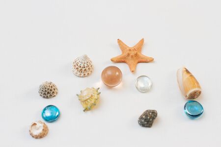 starfish and shells souvenirs, pebbles on a white background