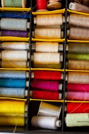 a set of multi-colored skeins of thread for sewing in a caseの写真素材