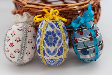a fabric easter decorative eggs and wicker basket