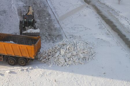 snow-removing machine on a dirty roadの写真素材